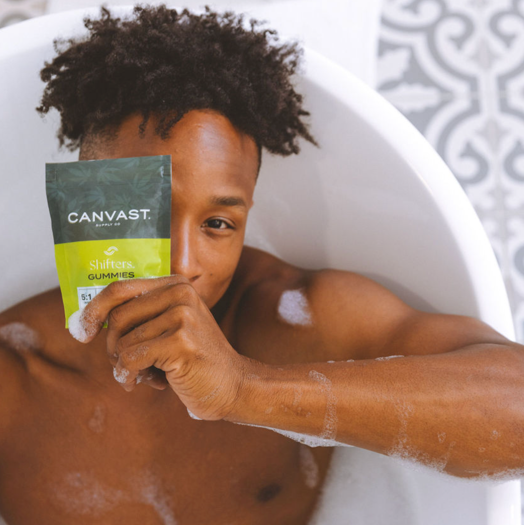 Will CBD Gummies Help With Pain? Handsome man in bath tub enjoying cannabis, delta-8 gummies