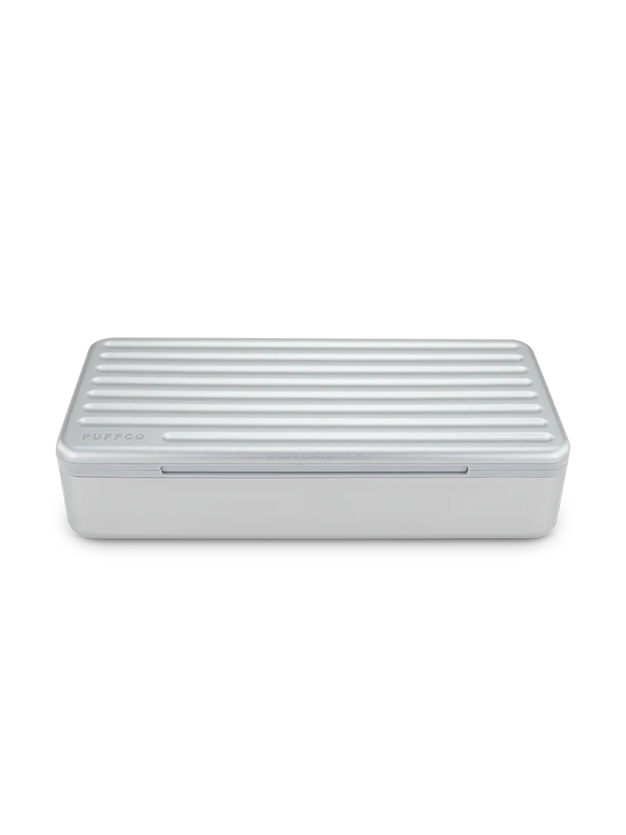 The Travel Case keeps your stash organized. Featuring a ridged hard aluminum exterior with a magnetic lid closure and soft silicone inside to reduce rattling, the Travel Case has room for a Pivot + Hot Knife, up to 3 jars, cotton swabs, a covered section for trash, and anything else you might need.