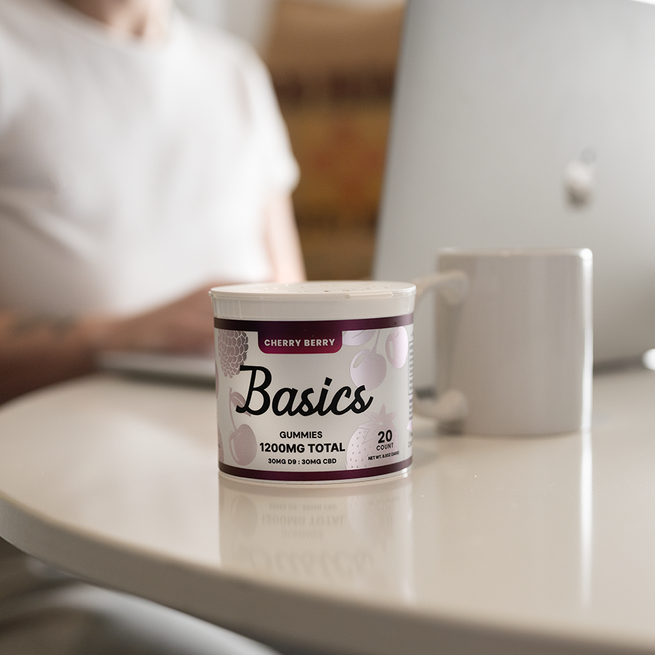 Container labeled 'Basics' on a table with a blurred person in the background