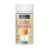 A bottle of Canvast Classic Caramels CBD edibles, featuring a beige label with brown text, an illustration of two caramel cubes, and a white ribbed cap, set against a plain white background.