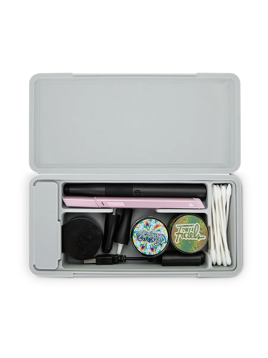 The Travel Case keeps your stash organized. Featuring a ridged hard aluminum exterior with a magnetic lid closure and soft silicone inside to reduce rattling, the Travel Case has room for a Pivot + Hot Knife, up to 3 jars, cotton swabs, a covered section for trash, and anything else you might need.